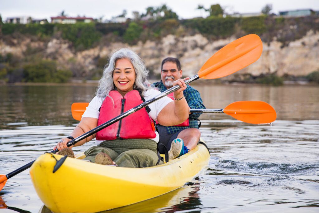 Older latinx couple kayaking