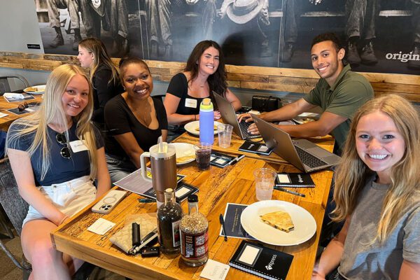 Emerging Professionals - AF and KAP table Team Smiling for Photo