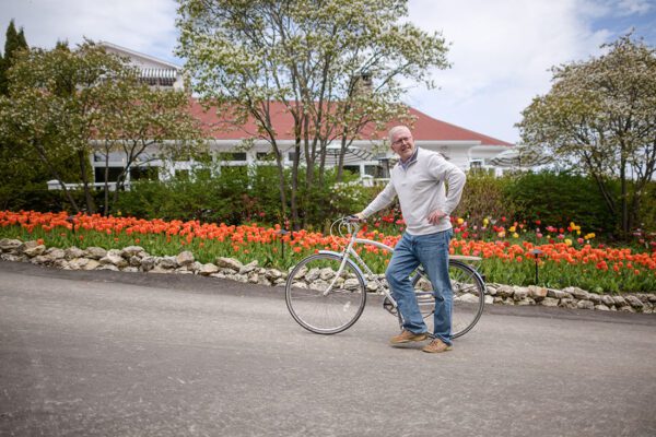 Kapnick Strive - Standing Outside With Bike By Flowers Blooming